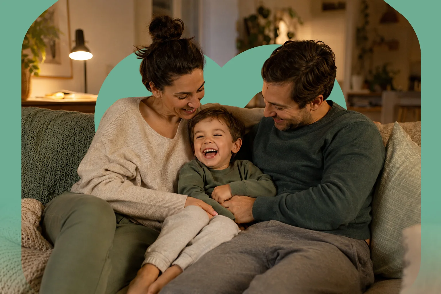 Parents and their child smiling together at home on the couch